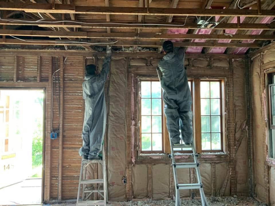 Two framers on ladders mid-build.