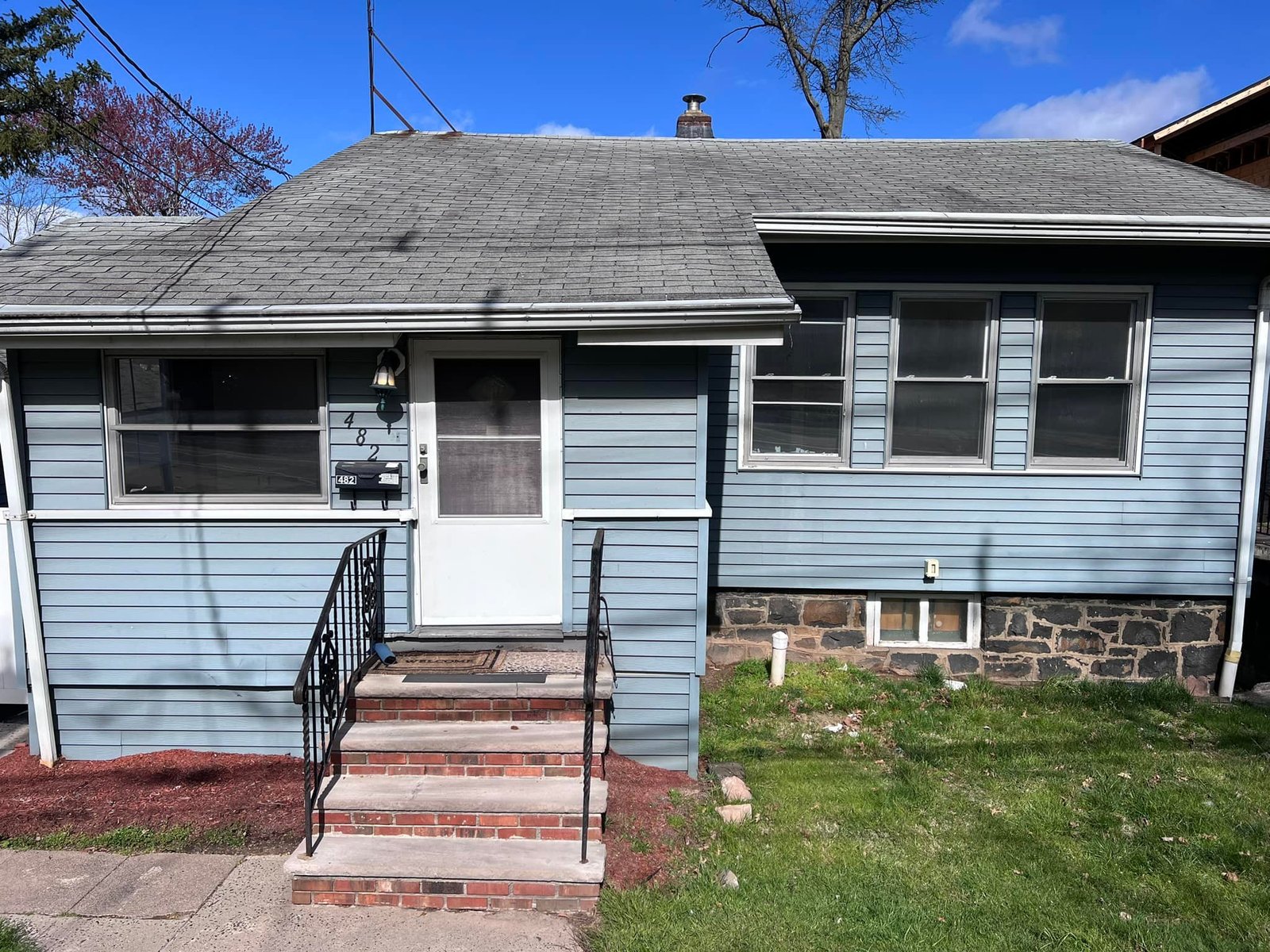 Front of the house when I bought it. Old roof, weathered siding, sad-looking trim.