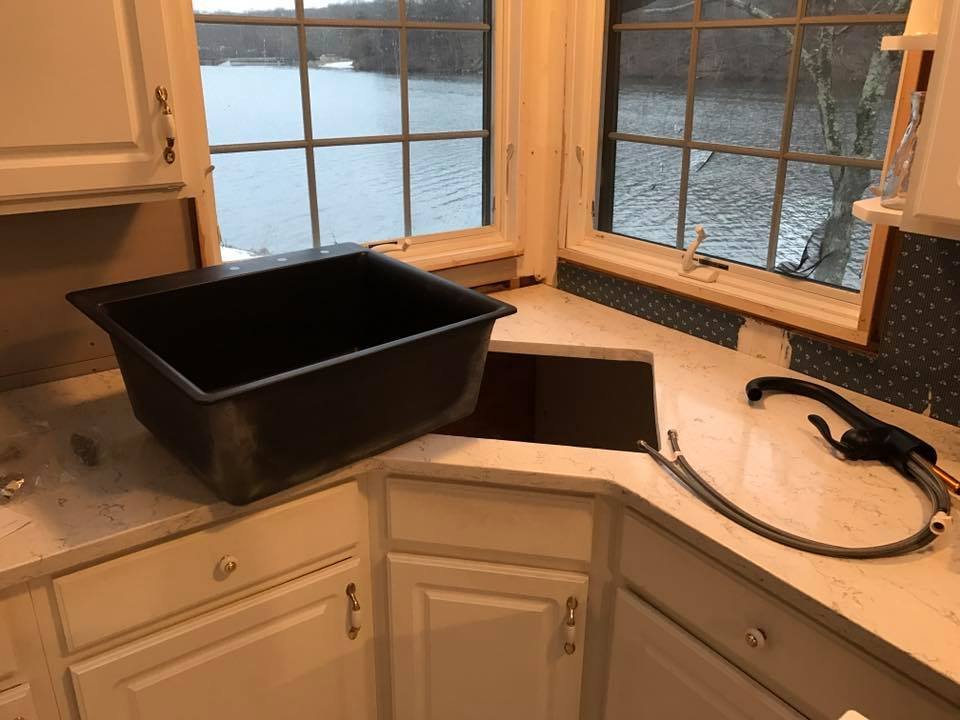 Sink and faucet sitting on the new quartz before I dropped it in. Corner cutout was tight.