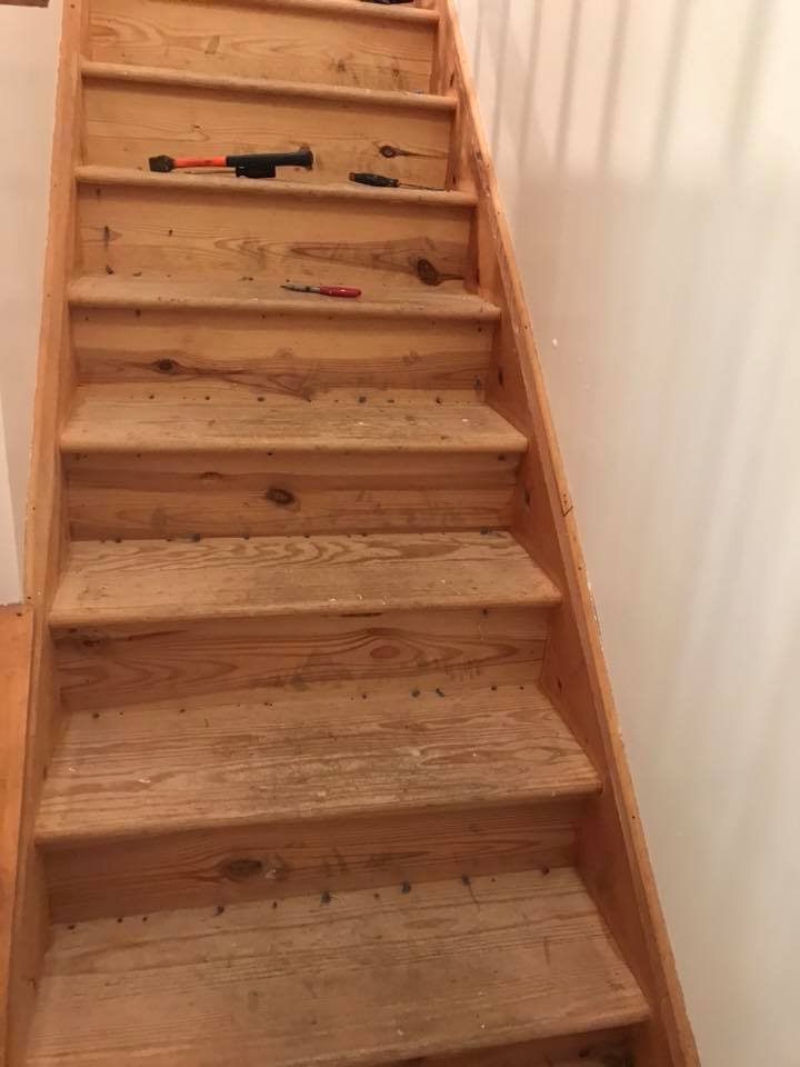 Stairs sanded down to bare wood. Tools left where I stopped at the end of the day.