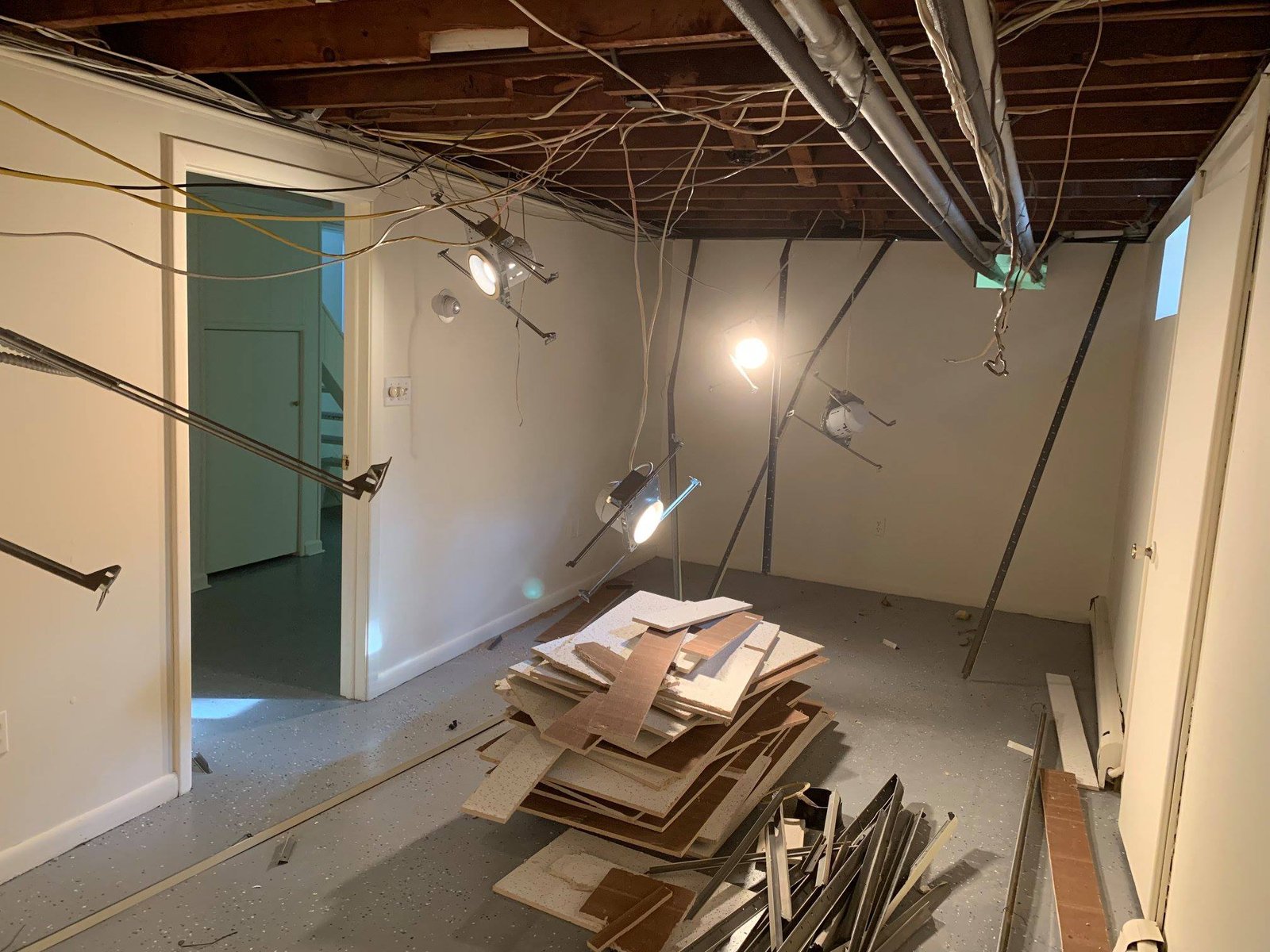 Drop ceiling out, joists and ductwork exposed. Stacked the tiles in case any could be reused.