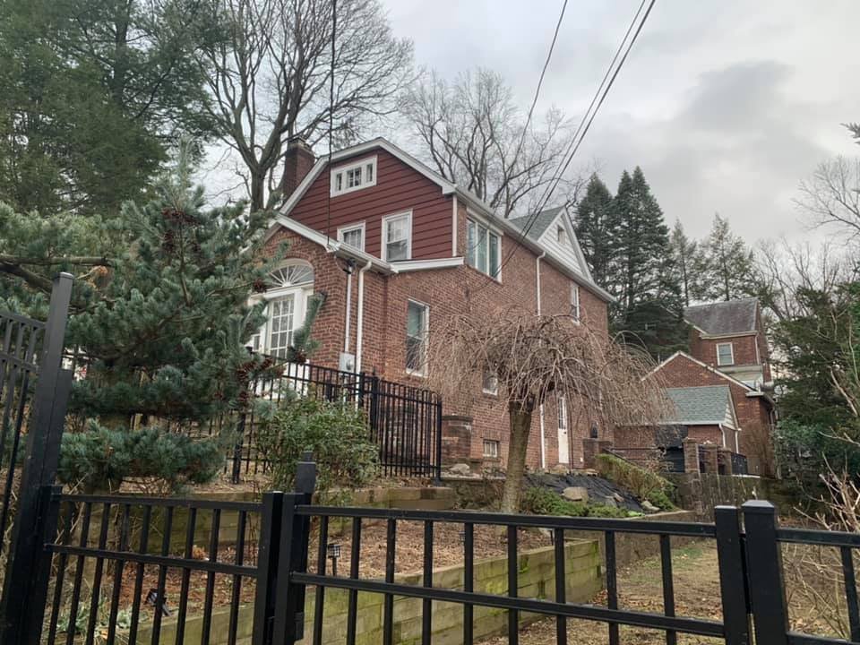 Front of the house before any of the exterior work started. Old wrought iron and overgrown beds.