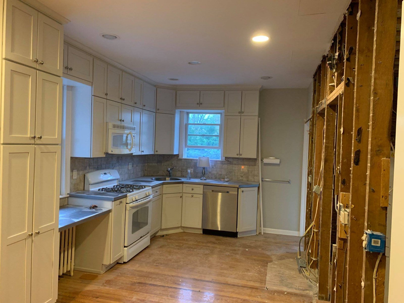 Old cabinets still standing on one side, demo wall stripped to studs on the other. Worked it in halves.