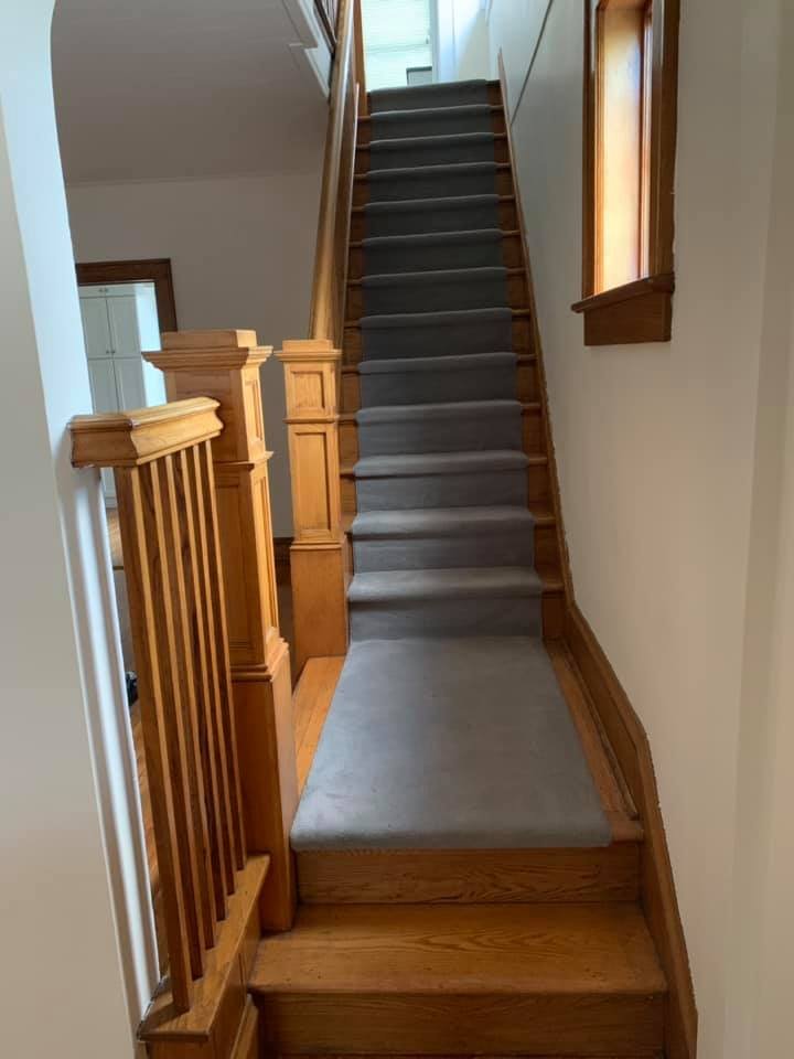 New gray runner on the oak stairs after I refinished the treads and kept the original balusters.