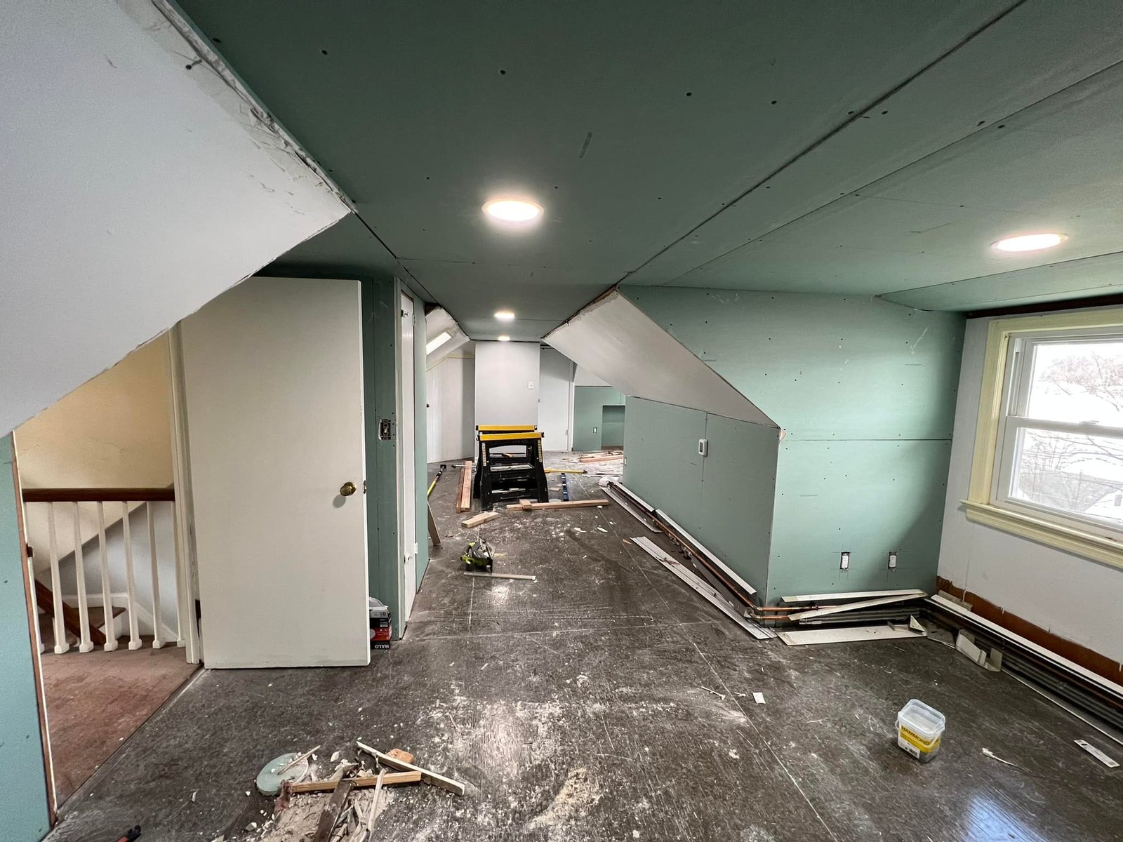 Green board going up on the sloped ceilings with the recessed cans already roughed in.