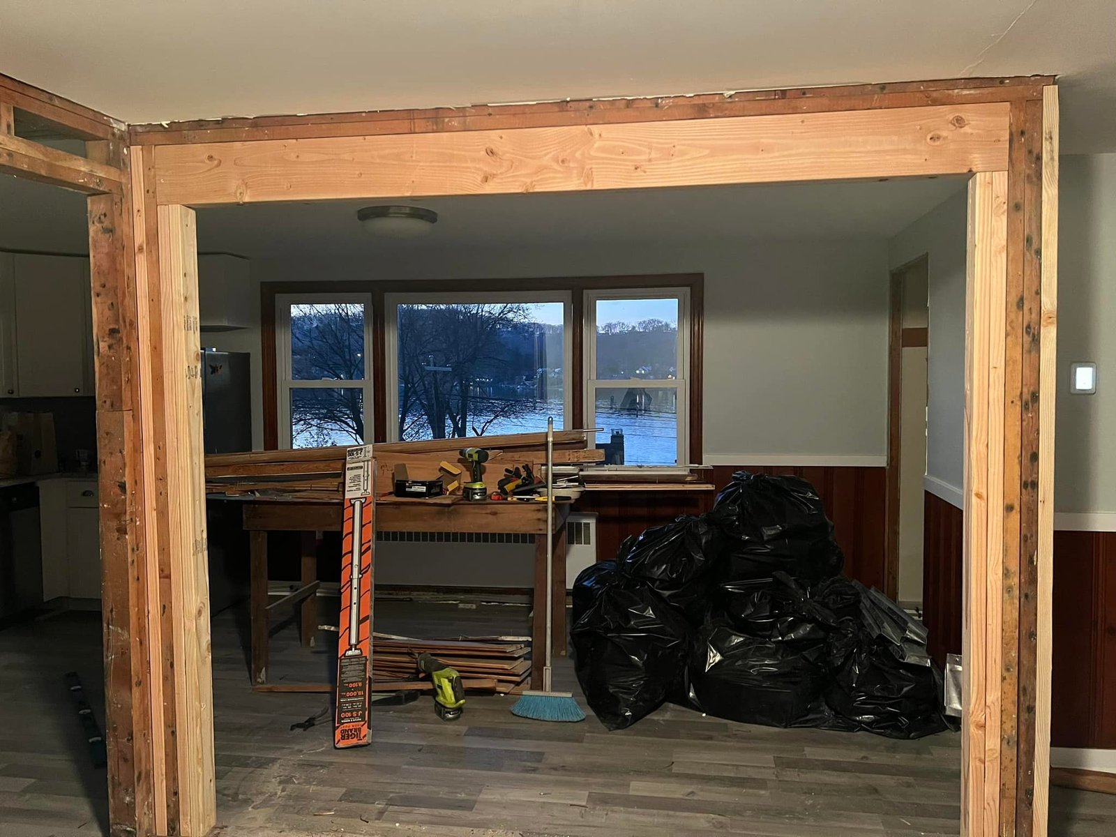 New LVL beam set across the opening between kitchen and living room. Lake view all the way through.