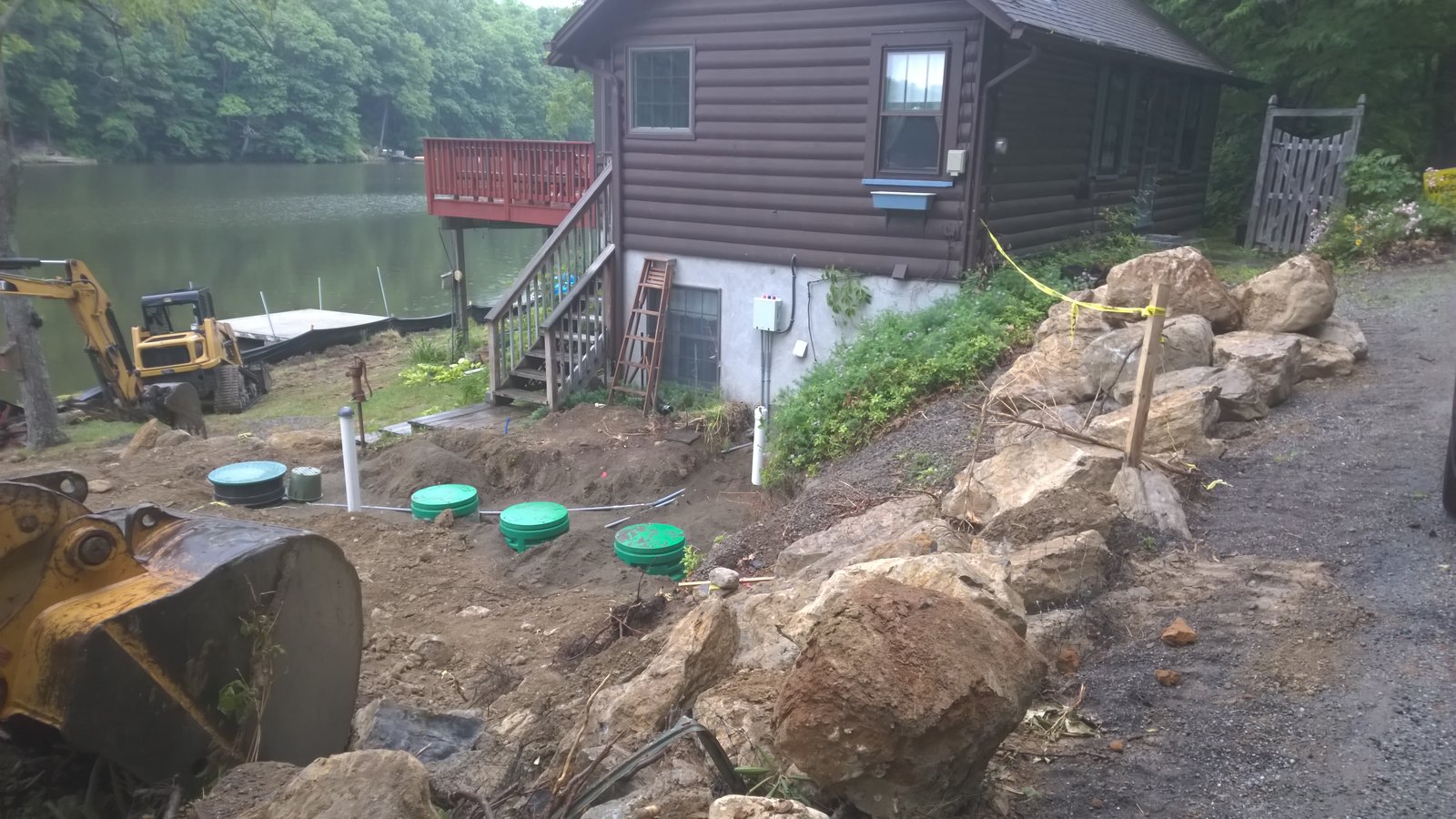 Fresh tank lids next to the cabin. Tied them in alongside the boulder retaining wall I was building.