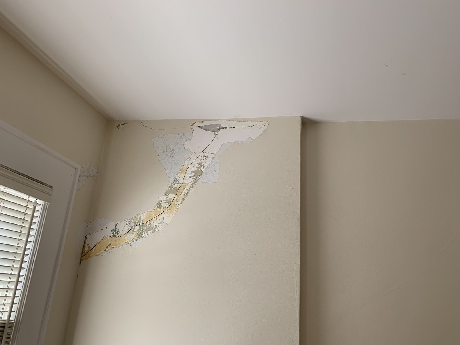 Water had run down this corner long enough to blow the seam tape and peel the drywall paper. Had to cut it back.
